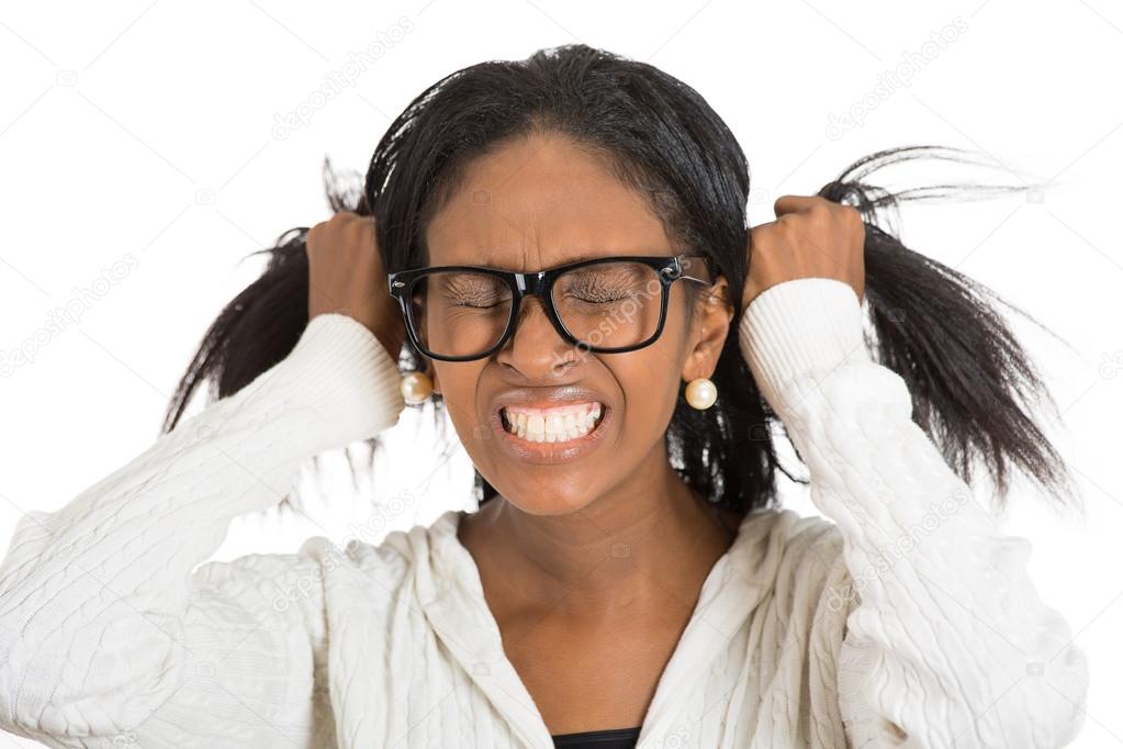 Frustrated stressed woman with glasses pulling her hair out 