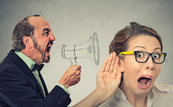 Angry man screaming in megaphone curious nosy woman listening — Stock Photo, Image