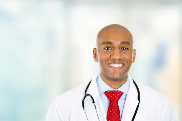 Happy confident young doctor standing in hospital hallway — Stock Photo, Image