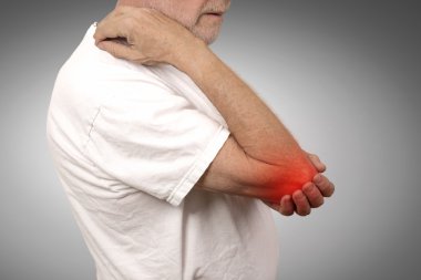 senior man with elbow inflammation colored in red suffering from pain  clipart