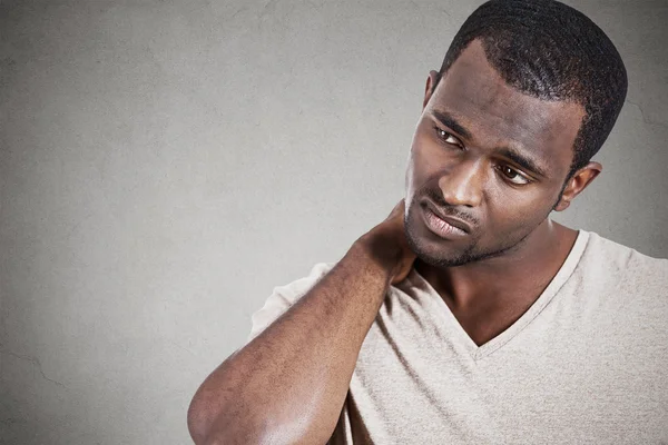 Stressed, unhappy young handsome man with neck pain — Stock Photo, Image