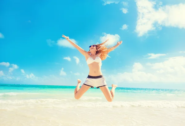 Boldog asszony ugrás In The Air birtoklás móka a Tropical Beach — Stock Fotó