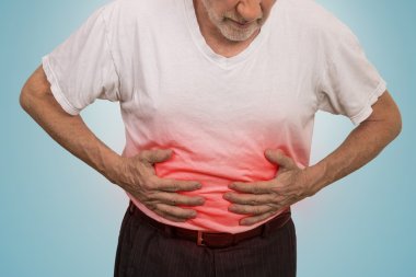 Stomach ache, man placing hands on the abdomen clipart