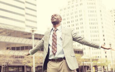 man celebrates freedom success arms raised looking up clipart