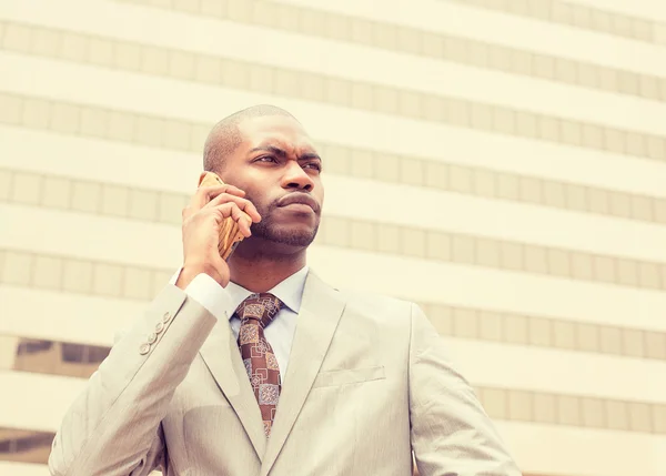 Handsome young businessman talking on mobile phone — Stock Photo, Image
