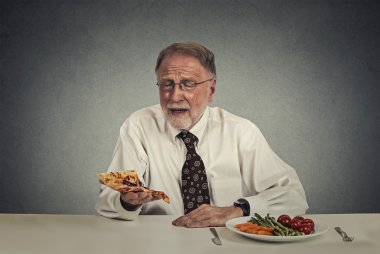 Sad man looking at pizza tired of salad diet clipart