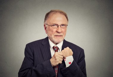 senior man pulling out a hidden ace card from suit jacket sleeve clipart