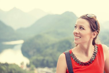 Closeup happy woman with Bavarian Alps Germany at sunset background 