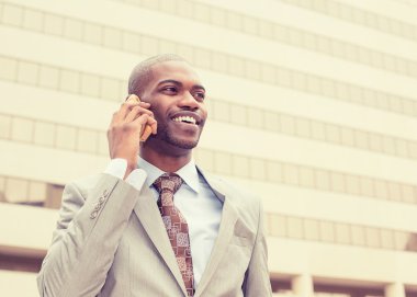 businessman talking on cell phone outside