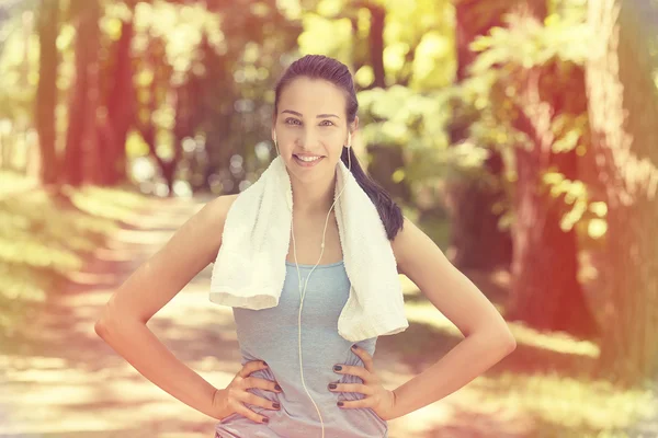 Young woman with white towel resting after workout — Stockfoto