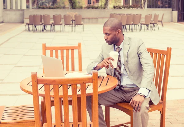 Homme d'affaires travaillant à l'extérieur lisant des documents buvant du café — Photo