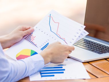 Cropped image hands with financial charts papers