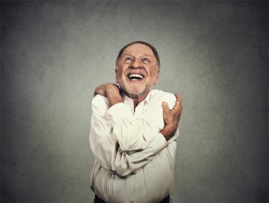 smiling man holding hugging himself