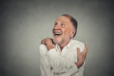 smiling man holding hugging himself