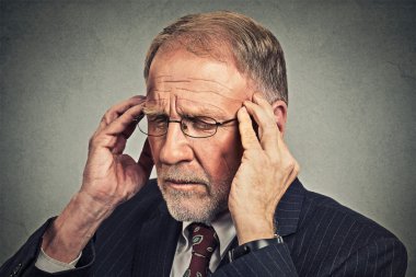 stressed senior man looking down sad depressed, alone, disappointed