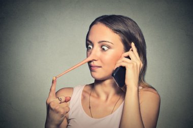 Liar woman with long nose talking on mobile phone 