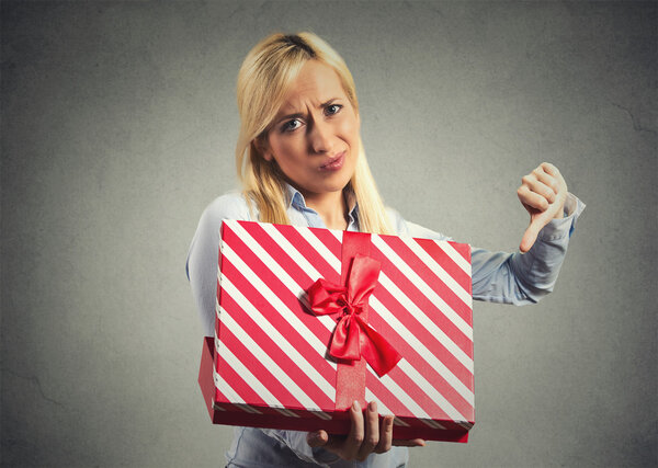 woman holding, opening gift box, displeased with what she received