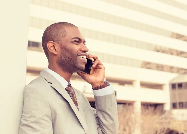 Handsome happy young businessman talking on mobile phone — Stock Photo, Image