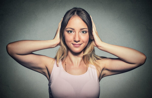 happy woman covering with hands her ears 