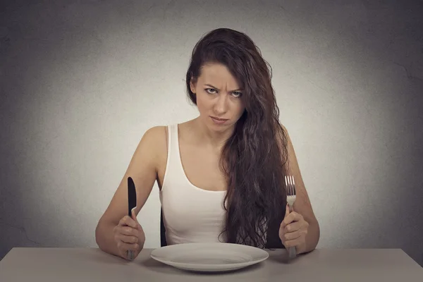 Skeptical dieting woman tired of diet restrictions looking frustrated Stock Photo