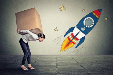 Woman with big goals carrying large box. Career challenge target concept 