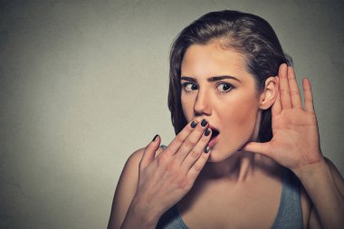 surprised nosy woman with hand to ear gesture listening 