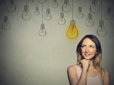 Big idea. Happy smart girl with solution lightbulb above head