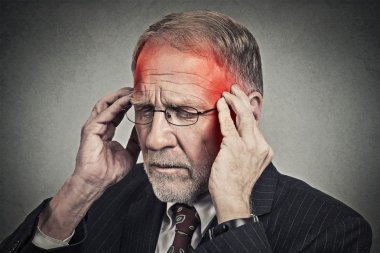 headshot senior man suffering from headache hands on head 