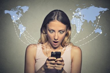 shocked woman looking at her smart phone seeing bad news or photos