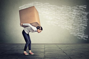 Stressed woman carrying on her back shoulders large bo