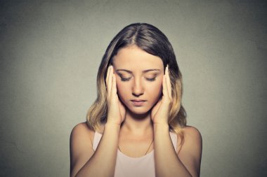 stressed sad young woman with eyes closed 