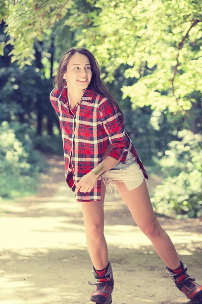 Patinaje niña en el parque patinaje sobre patines en línea — Foto de Stock