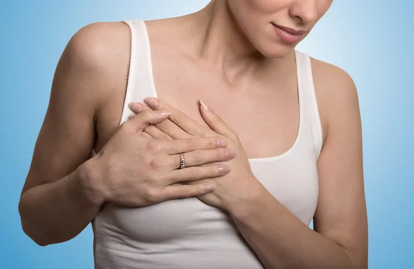 Cropped portrait young woman with breast pain touching chest — Stockfoto