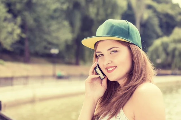 Cheerful young happy woman talking on mobile phone — Stock Photo, Image