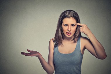 angry mad young woman gesturing asking are you crazy?