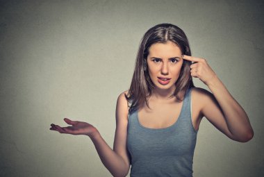 angry mad young woman gesturing asking are you crazy? clipart