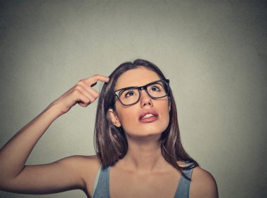 woman scratching head, thinking daydreaming deeply about something