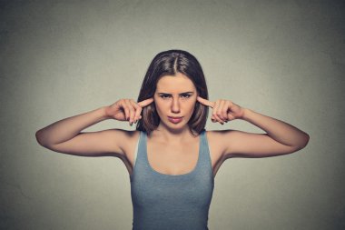 angry unhappy woman with closed ears looking at you annoyed 