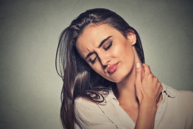 tired woman massaging her painful neck clipart
