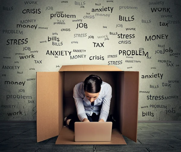 Woman hiding in the box working on computer — Stok fotoğraf