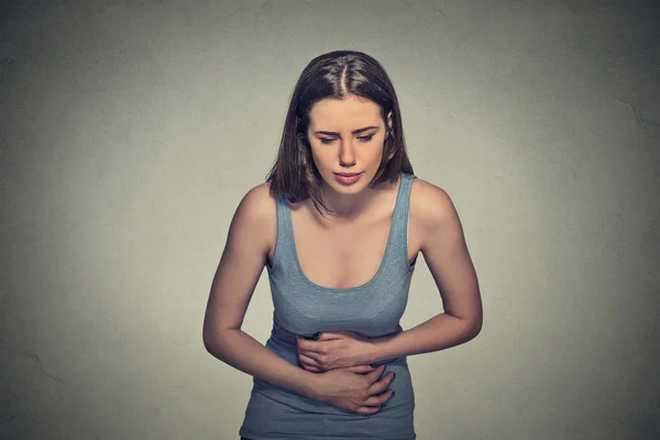 Woman hands on stomach having bad aches pain — Stock Photo, Image