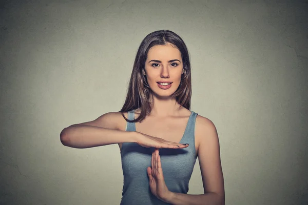 Happy, smiling woman showing time out gesture with hands — Stockfoto