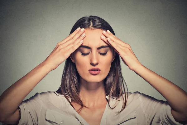 stressed sad young woman with eyes closed having bad day