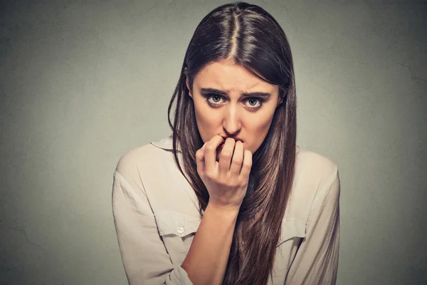 Young anxious unsure hesitant nervous woman biting her fingernails — Zdjęcie stockowe