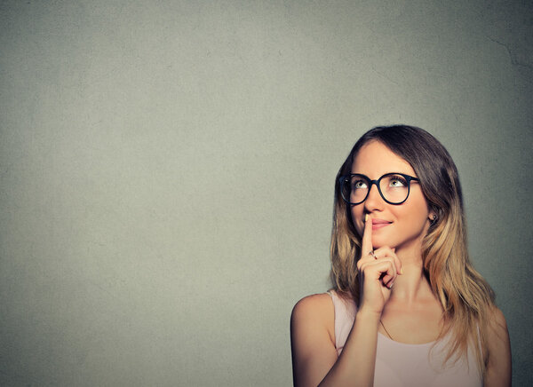 happy young woman thinking dreaming has ideas looking up 