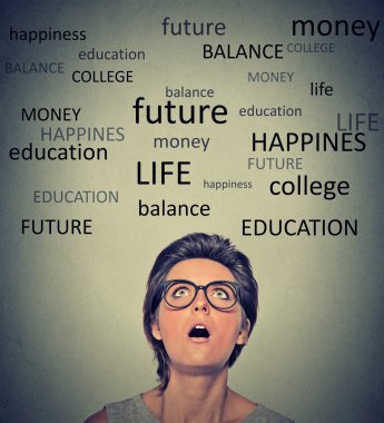 woman with glasses wondering planning future life looking up
