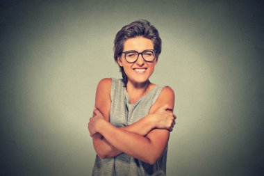 confident smiling woman holding hugging herself