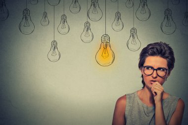 young woman with glasses thinking hard looking for right solution
