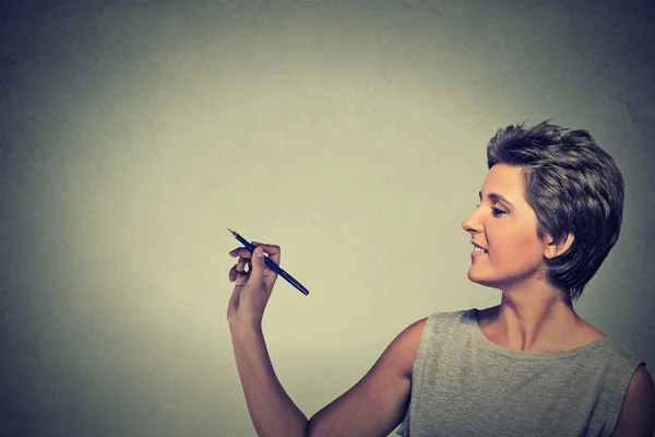 Young woman drawing writing on board with empty copy space — Stockfoto