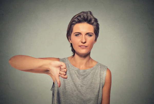 Unhappy, angry, pissed off woman, annoyed giving thumbs down gesture — Stockfoto